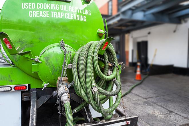 a grease trap pumping service in action at a commercial building in Baldwin Park